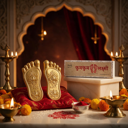 Kumkum Lakshmi agarbatti with golden Lakshmi feet on a red cushion and diyas