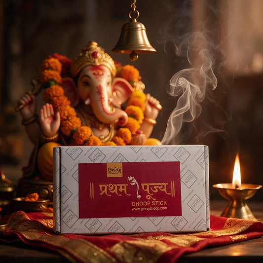 Pratham Pujya Dhoop Stick box on red silk with a Ganesha idol and brass temple bell