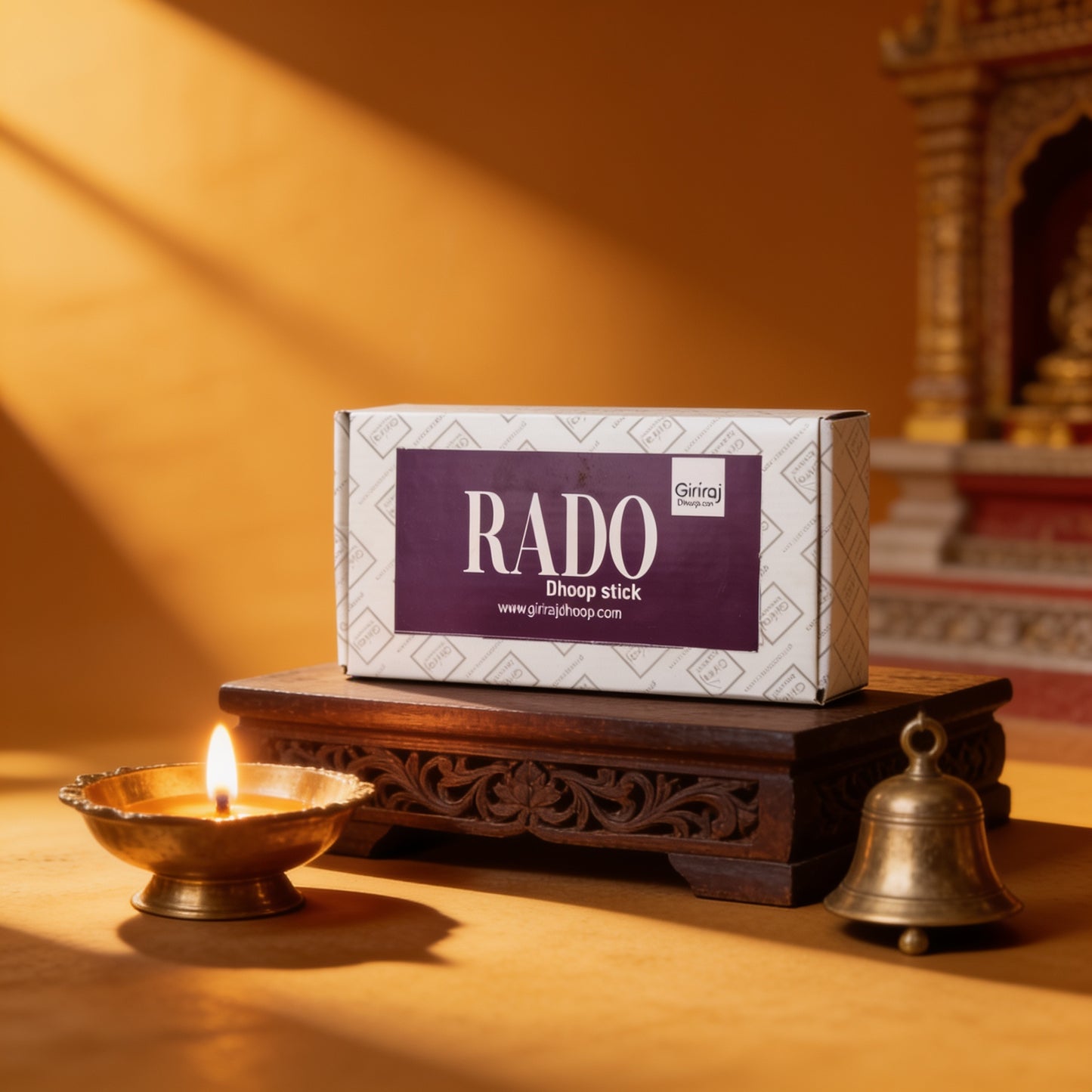 Rado Dhoop Stick box in a traditional puja setting with brass diya and bell