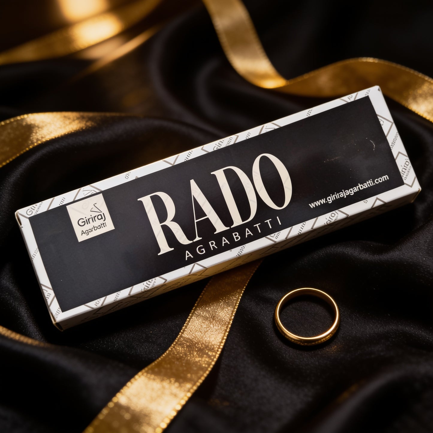 Rado Agarbatti incense box on black silk with a gold ring
